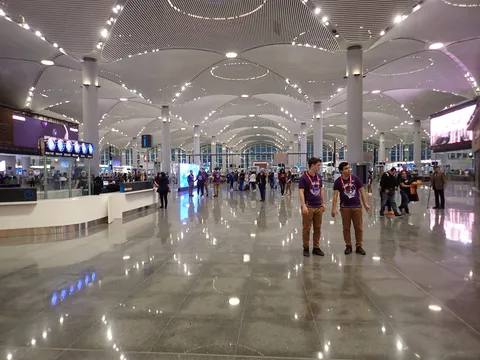 Wide interior hall of Istanbul Airport's departure area with high ceilings