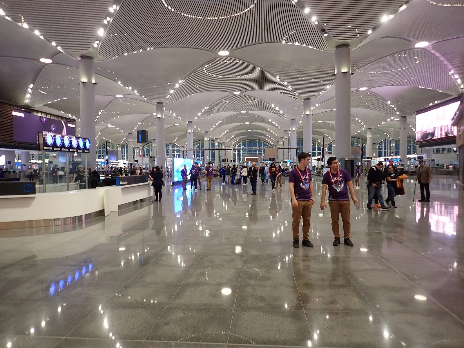 Wide interior hall of Istanbul Airport's departure area with high ceilings